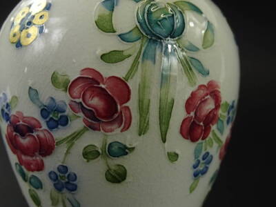 A McIntyre Florian type ware small vase, with tube lined decoration of swags of blue and red flowers, patera etc., signed by William Moorcroft to the underside, pattern number 2717, 11cm H. - 3