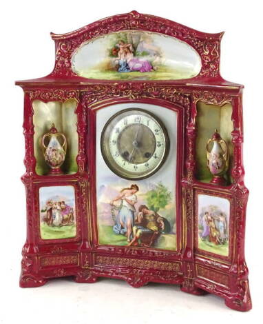 A late 19th/early 20thC Continental porcelain mantel clock, decorated overall with printed panels in the manner of Angelica Kauffman, the central enamel dial flanked by stylised recesses, each with a two handled vase and cover, within gilt borders, on scr