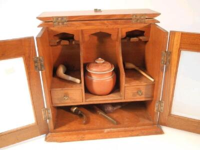 An Edwardian oak smokers cabinet