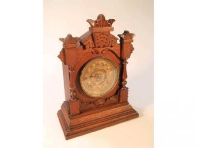 A late 19thC oak mantel clock with brass dial