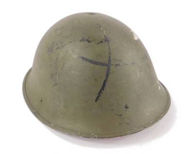 A green painted metal army helmet, 7 Fil, dated 1952.