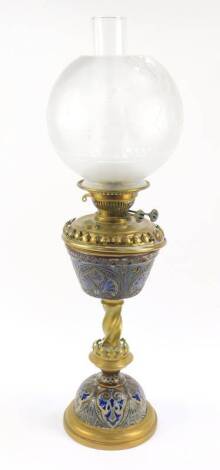 A Doulton Lambeth late 19thC stoneware and brass oil lamp, with sgraffito stylised floral motifs, with chimney, and frosted globular brass shade, 65cm H. (AF)