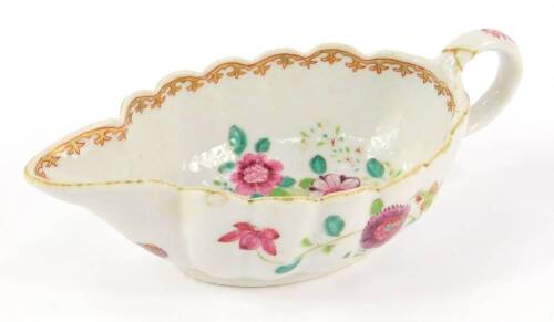 A Chinese late 18thC export porcelain sauce boat, famille rose decorated with flowers, 20cm L. (AF)