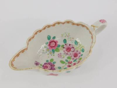 A Chinese late 18thC export porcelain sauce boat, famille rose decorated with flowers, 20cm L. (AF) - 2