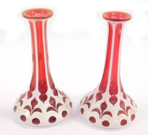 A pair of Continental late 19thC white and ruby flash glass scent bottles, with gilt vermicelli decoration, stoppers lacking, 18cm H.