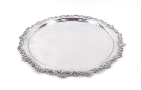 A silver plated circular salver, with embossed rococo shell and scroll rim, stamped H H & S, 2671, 31cm Dia.