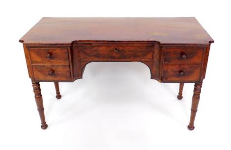 A Victorian mahogany breakfront desk, with a central drawer flanked by two short and one deep drawer, raised on turned legs.