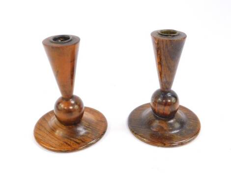 A pair of Art Deco oak candlesticks, of bud form, with copper liners, 13.5cm H.