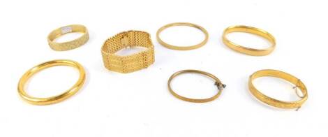 Seven bangles, comprising four hinged bangles, plated, a etched floral design bangle, and a heavygold plated bracelet.