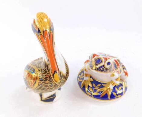 A Royal Crown Derby imari paperweight modelled as a brown pelican, c1998, together with a frog paperweight, modelled on a circular base. (2)