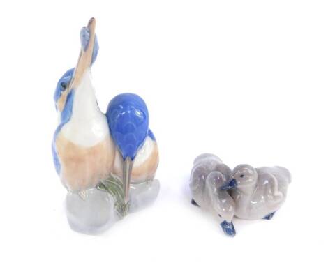 A Royal Copenhagen porcelain figure group modelled as a pair of Kingfisher, No 114, printed and painted marks, together with a pair of ducklings, No 363, printed and painted marks. (2)