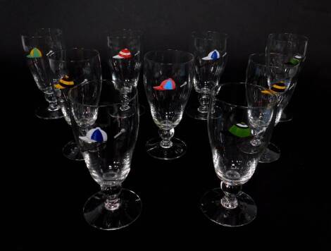 A set of nine mid 20thC ale glasses, enamel decorated with riding caps and crops.