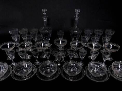 A Moser of Karlsbad cut glass part suite of table glass, decorated with an etched band of stylised acanthus and scrolling leaves, comprising a pair of decanters, seven champagne cups, six red and seven white wine glasses, eight port glasses, three liqueur