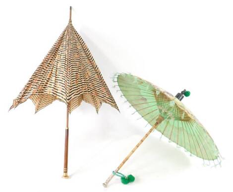 An Edwardian silk parasol, decorated with black and white stripes and roses, with a wooden and gilt metal handle, 94.5cm L, together with a Far Eastern painted silk parasol, with embossed white metal handle, metal cased, 65cm L. (2)