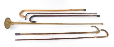 Three Victorian bamboo walking canes, one with a horn handle, two walking sticks, and a brass hunting horn, 102cm L. (6)