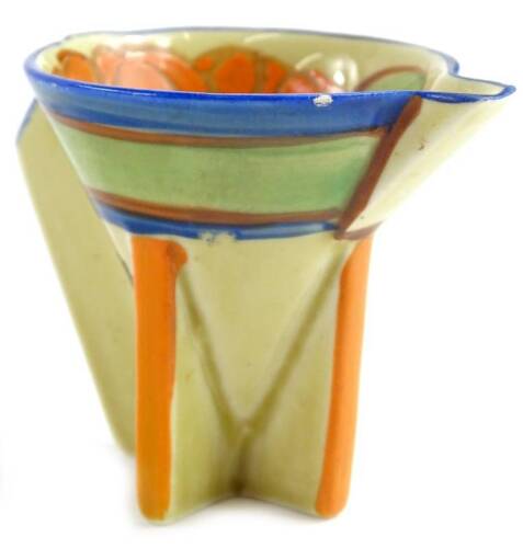 A Clarice Cliff Art Deco miniature cream jug, decorated in orange and green within a blue border, on angular feet, indistinct stamp to side, 6cm H.