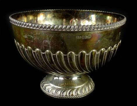 An Edwardian silver rose bowl or cup, with gadrooned border, part fluted decoration, on a domed foot, Birmingham 1907, 19oz, 21cm dia.