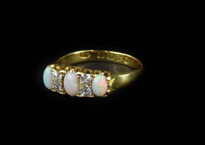 An 18ct gold opal and diamond gypsy ring, set with three oval opals, and four tiny diamonds, in claw setting, ring size O, 4.1g all in.