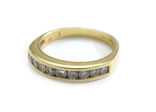 An 18ct gold half hoop diamond eternity ring, set with nine round brilliant cut diamonds, marked to band .5cts, each in tension setting, ring size M½, 3.7g all in.