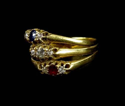 A three row dress ring, set with three dress rings each stone set with three stones, including a three stone diamond ring, a sapphire and diamond ring, and a garnet and diamond ring, joined together to make one ring, yellow metal, unmarked, ring size S, 5