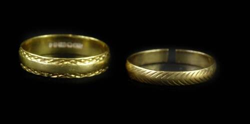 Two wedding bands, to include an 18ct gold band, with cross design borders, ring size T½, and a 9ct gold wedding band with etched design, 1.9g. (AF)