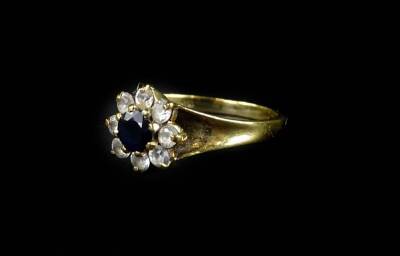 A 9ct gold cluster dress ring, with central dark blue stone, surrounded by imitation diamonds, ring size L, 2.6g all in.