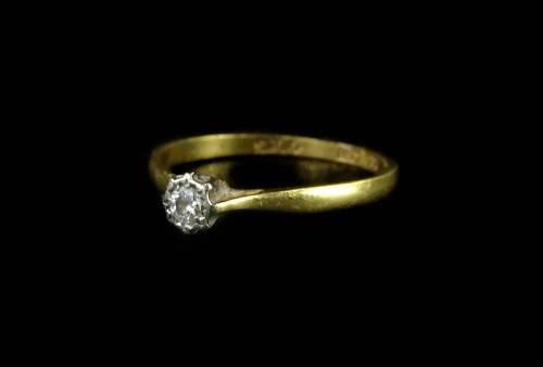 A diamond solitaire ring, with round brilliant cut diamond, approx 0.2cts, in a rub over platinum settings, on gold band, marked 18ct & plat, ring size P, 2.1g all in.