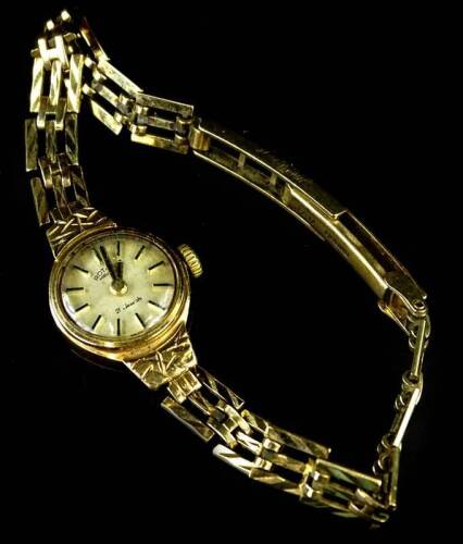 A 9ct gold Rotary ladies wristwatch, with oval watch head and 21 jewel movement, with three row bar bracelet, maker J.A.M, 11.4g all in.