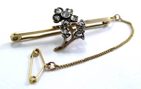 A 9ct gold bar brooch, with a floral motif, set as a flower with six stones and three leaves, each set with stone, the brooch 4.5cm W, with safety chain in box for F.PERSE Chatham.