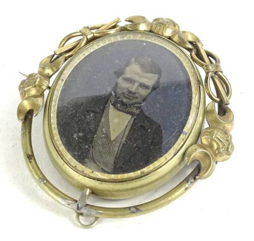 A Victorian memorial brooch, with central figure, believed to be John Charles Rudkin of Derby, with memorial lockets to back, in gilt frame, 11cm H.