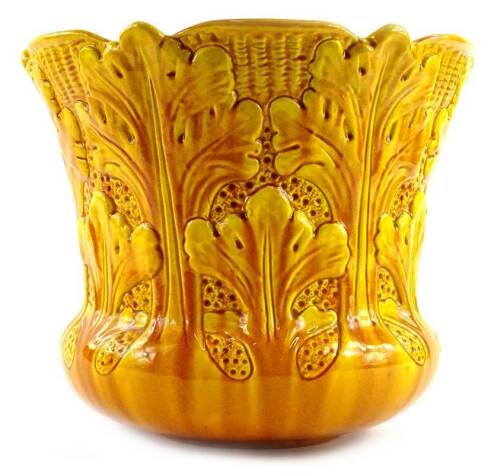 A Burmantoft pottery jardiniere, moulded with yellow flowers, impressed marks to underside, number 2036, 23cm H.