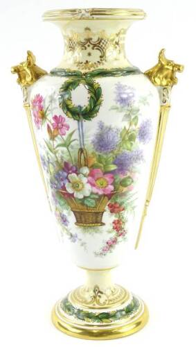 A Spode Copeland porcelain two handled vase, painted with a basket of flowers, reads etc., stylised gilt lion mask handles, printed mark in green to underside.