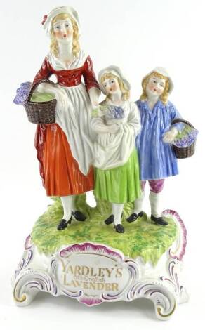 A porcelain Yardley's lavender soap advertising stand, cast with a lady and two children, the base stamped Yardley's Old English Lavender, 30cm H.