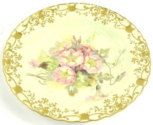 A Royal Crown Derby porcelain plate, painted with flowers within a gilt border, attributed to F. Williams, 23cm dia.