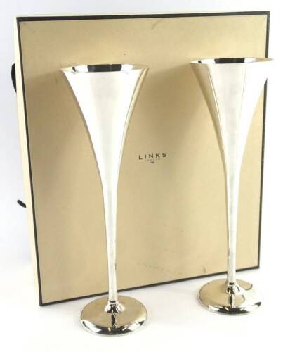 A pair of Links of London silver plated champagne flutes, each on a domed foot, with original box and cloth travelling bag, 25cm H.