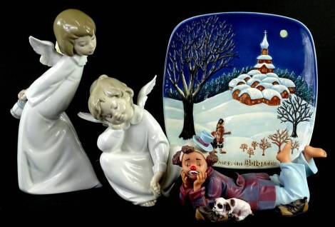 A Lladro porcelain figure of a young angel, and a smaller example a Nadal composition clown, and a Beswick Limited edition Christmas in Bulgaria plate. (4)