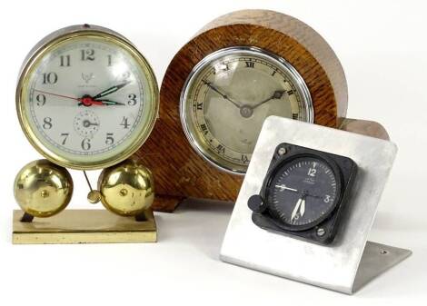 A small collection of clocks, to include a Nero Lemonia car clock, a small alarm clock and an oak mantel clock. (3)