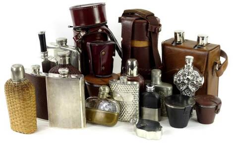 Various silver plated pewter and other hip flasks, sets of beakers etc., mainly in leather or leatherette carrying cases.