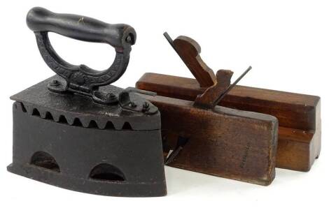 A Victorian cast iron flat iron, with turned wooden handle, unmarked, and two wooden planes. (3)