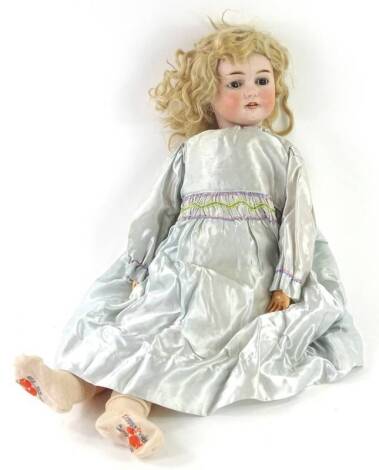 A Felix Arena Mignon bisque headed doll, with composition limbs, impressed aeroplane symbol marked to head, 65cm H overall.