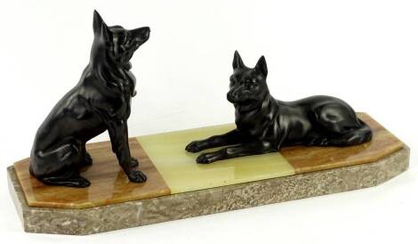 A French Art Deco spelter and marble mantel ornament, cast in the form of two German Shepherds or Alsatian dogs, on a rectangular canted plinth 49cm L.