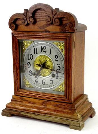 A German mantel clock in oak case, the square dial with Arabic numerals, signed RL Cozens Taunton, 36cm H. Provenance: This timepiece formed part of Luke Jerram's installation Harrison's Garden, at The Ropewalk Gallery, Barton Upon Humber 2019.