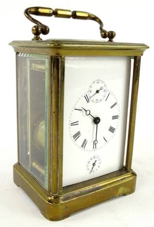 A late 19th/early 20thC French brass carriage timepiece, the white enamel dial with subsidiary seconds dial, alarm and Roman Numerals, (AF), 16cm H. Provenance: This timepiece formed part of Luke Jerram's installation Harrison's Garden, at The Ropewalk Ga