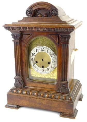 An early 20thC German walnut mantel clock, with arched engraved dial, silvered chaptering and carved case on block feet, (AF), possibly incomplete, 48cm H. Provenance: This timepiece formed part of Luke Jerram's installation Harrison's Garden, at The Rope