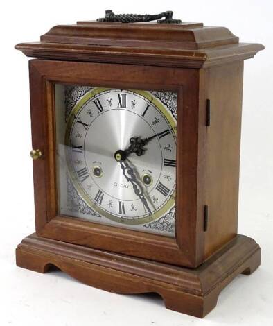 A German mahogany mantel clock in George III style, with brass movement, 32cm H. Provenance: This timepiece formed part of Luke Jerram's installation Harrison's Garden, at The Ropewalk Gallery, Barton Upon Humber 2019.