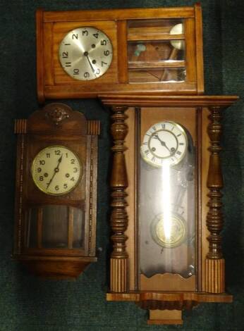 An early 20thC Vienna type wall clock, in a walnut case, the enamel type dial with Roman numerals, 65cm H, and two 1920's wall clocks. Provenance: This timepiece formed part of Luke Jerram's installation Harrison's Garden, at The Ropewalk Gallery, Barton 