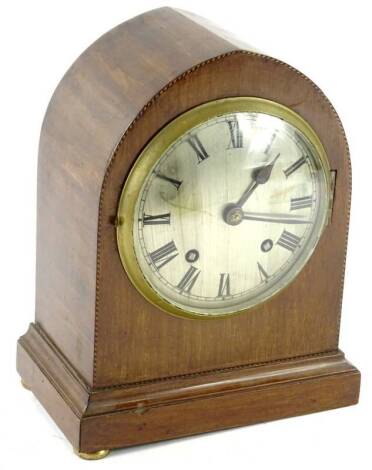 An Edwardian mahogany and chequer banded lancet shaped mantel clock, the silvered dial with Roman numerals, 26cm H. Provenance: This timepiece formed part of Luke Jerram's installation Harrison's Garden, at The Ropewalk Gallery, Barton Upon Humber 2019.