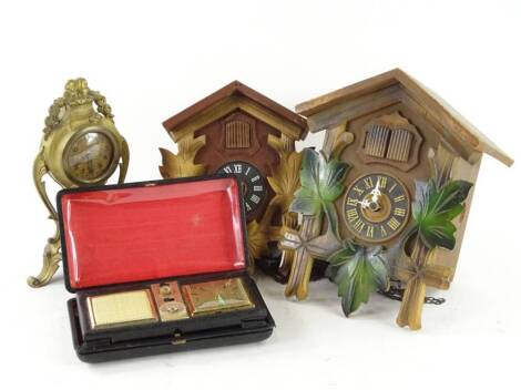 Various clocks, to include a gilt metal balloon shaped example, two cuckoo clocks and a clock radio. (4) Provenance: This timepiece formed part of Luke Jerram's installation Harrison's Garden, at The Ropewalk Gallery, Barton Upon Humber 2019.