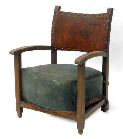 A stained beech child's chair, with a brown leather padded back and sprung cushion.