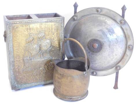 A collection of metalware, to include a shield shaped spark guard, brass coal bucket and a two division coal bucket, decorated with a galleon.